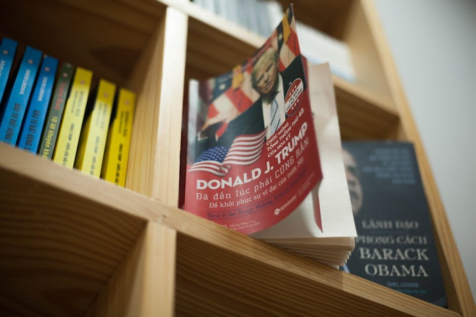 A close-up view of a bookshelf with books featuring political leaders in a bookstore setting.